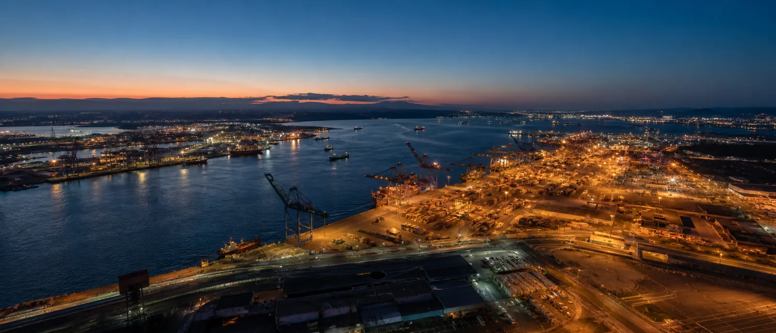 Container port and shipping lanes at dusk