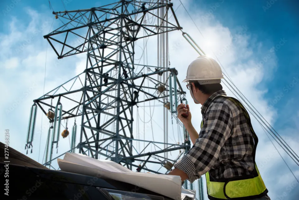 Engineer inspecting a transmission tower